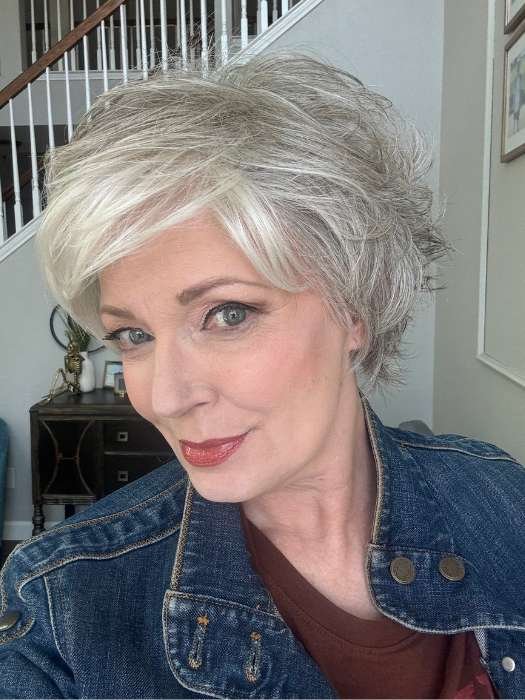 Short silver bob on mature woman wearing denim jacket showcasing short layered synthetic wig with textured layers