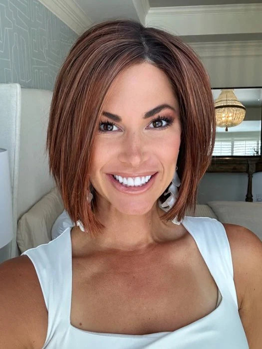 Smiling woman wearing short brown bob wig for women with subtle highlights straight texture and side part